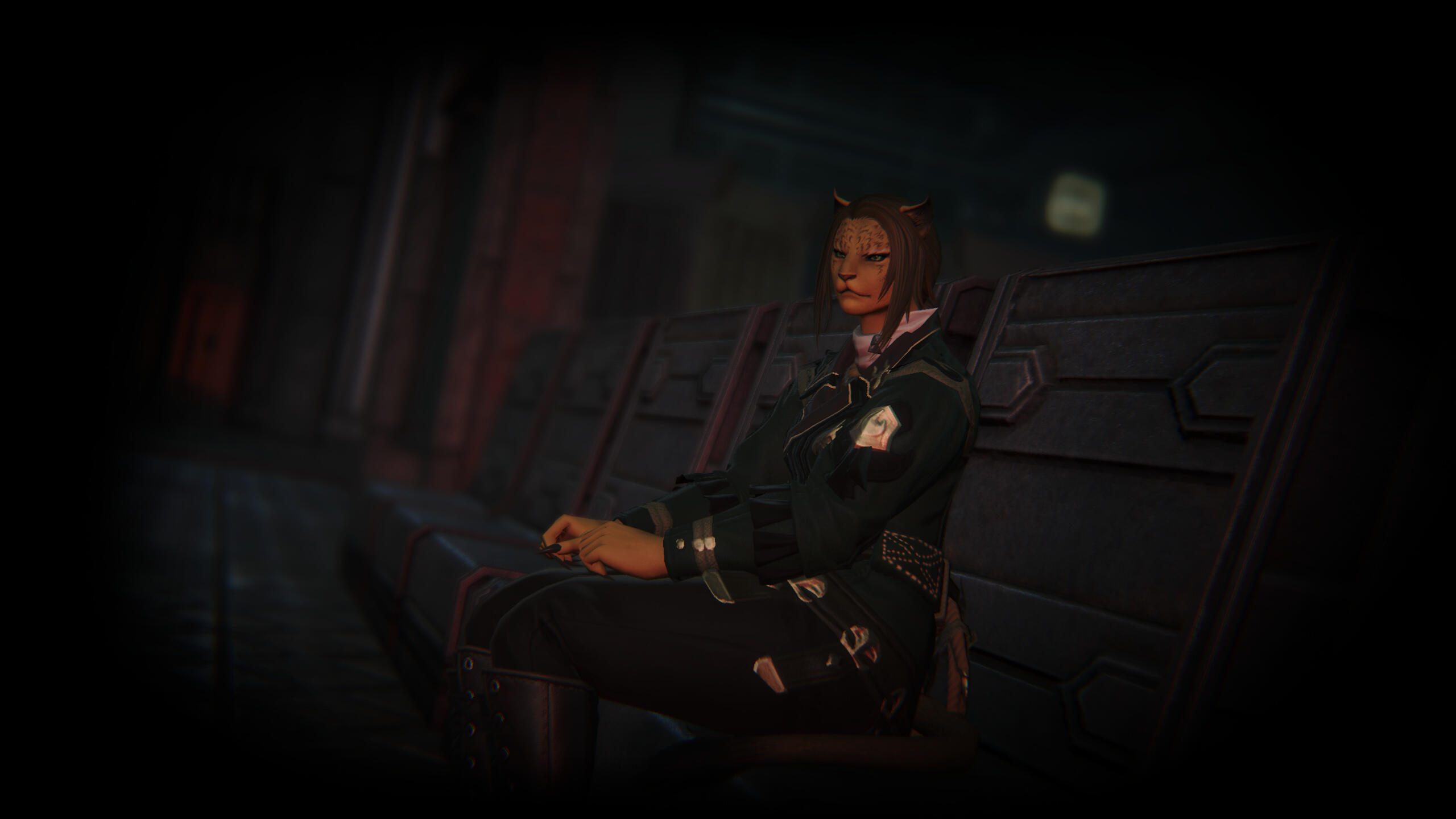 Nevrra Surasch sits upon a metal bench in a metal room. It all looks very Garlean, and is. There is a red light illuminating the area, which seems devoid of anything but herself. She has a military-like jacket on, but not Garlean in design. It's green.